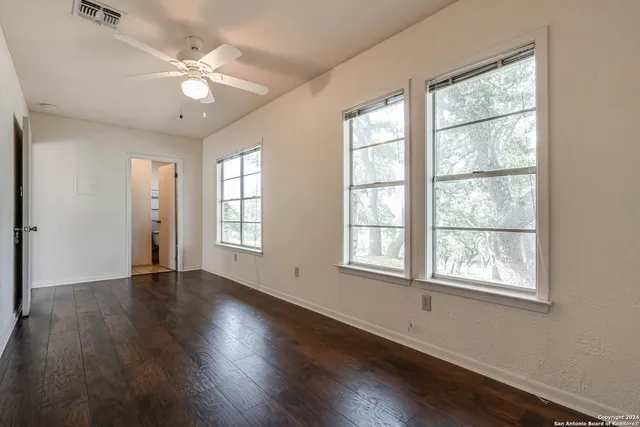 a view of a sink a mirror and cabinets