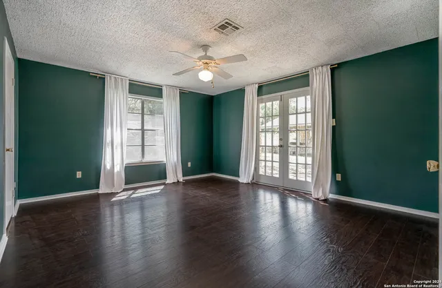 an empty room with wooden floor and closet