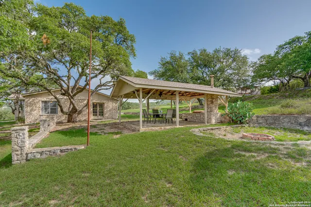 a view of a porch with furniture and yard