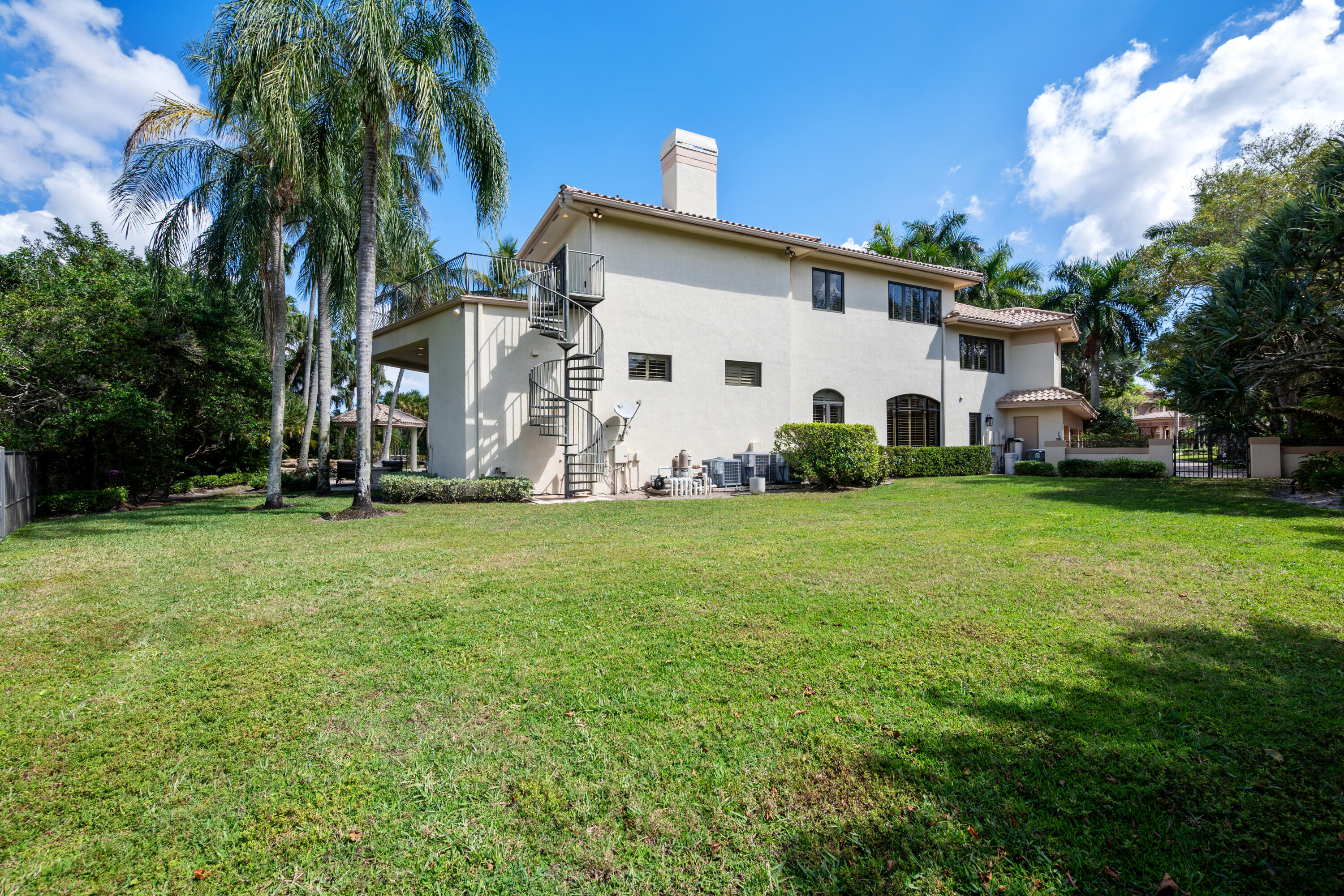 18800 Long Lake Drive Boca Raton, FL 33496 - Photo 60 of 60 a view of a white house with a big yard and large trees