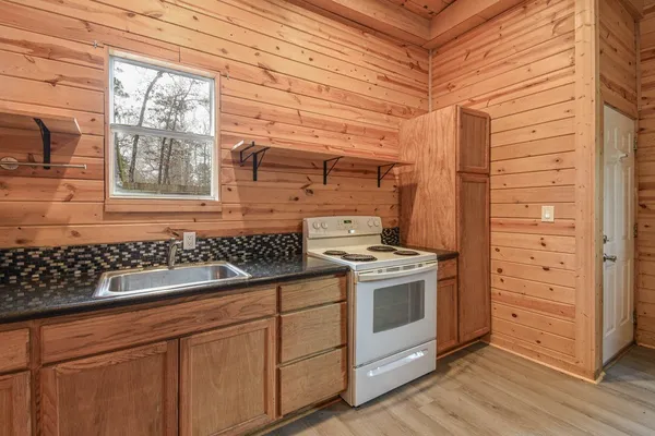 a kitchen with a stove and a window