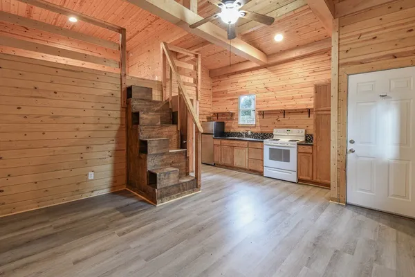 a kitchen with stainless steel appliances wooden floor and large cabinets