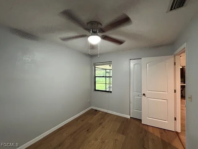 a view of room with window and ceiling fan