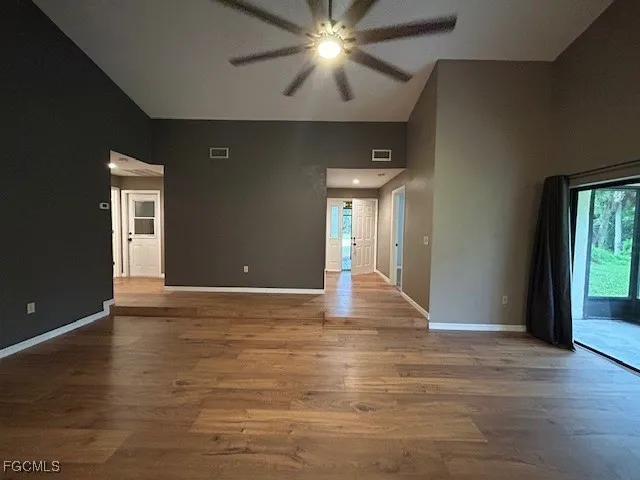 a kitchen with a stove and a wooden floor