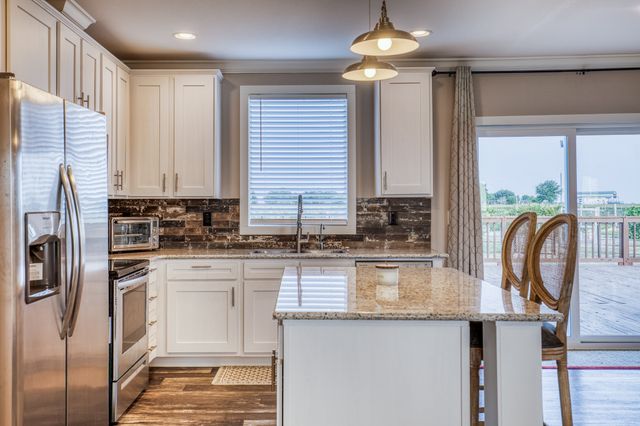 a bedroom with a large bed and a ceiling fan