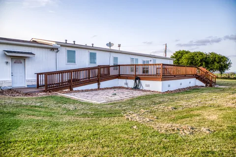 a view of a wooden fence with a bench in a yard
