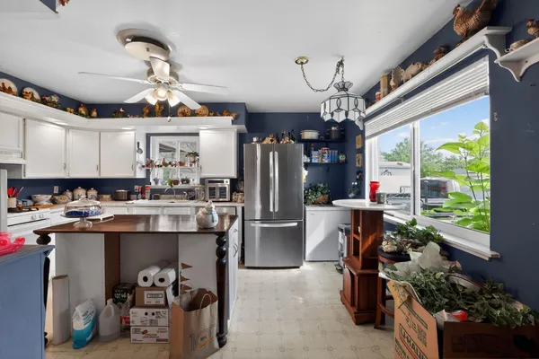 a kitchen filled a sink a counter and appliances