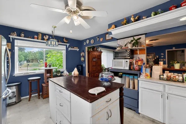 a kitchen with a stove a refrigerator and a dining table