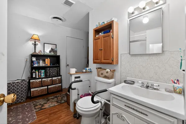 a bathroom with a sink toilet and mirror