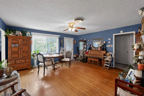 a living room with furniture and wooden floor