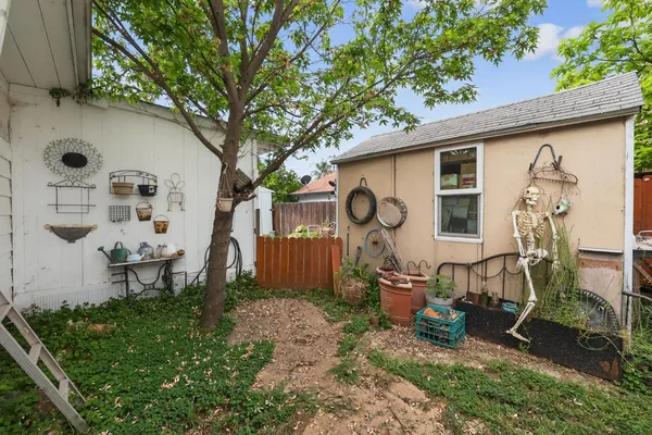 a view of a chair and table in backyard