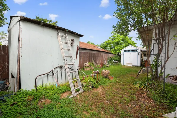 a wooden bench sitting in front of a house