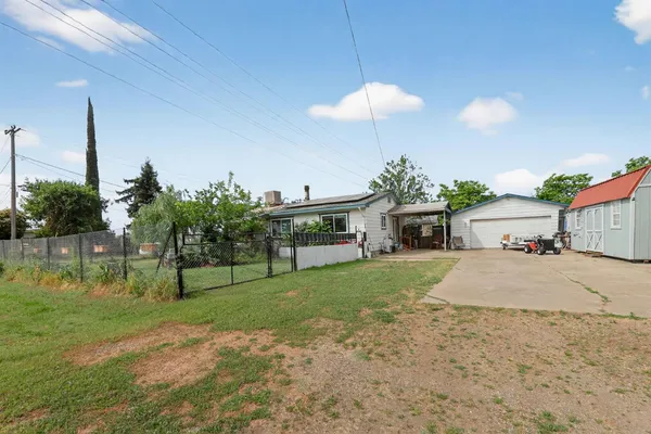 a view of a house with backyard and a patio