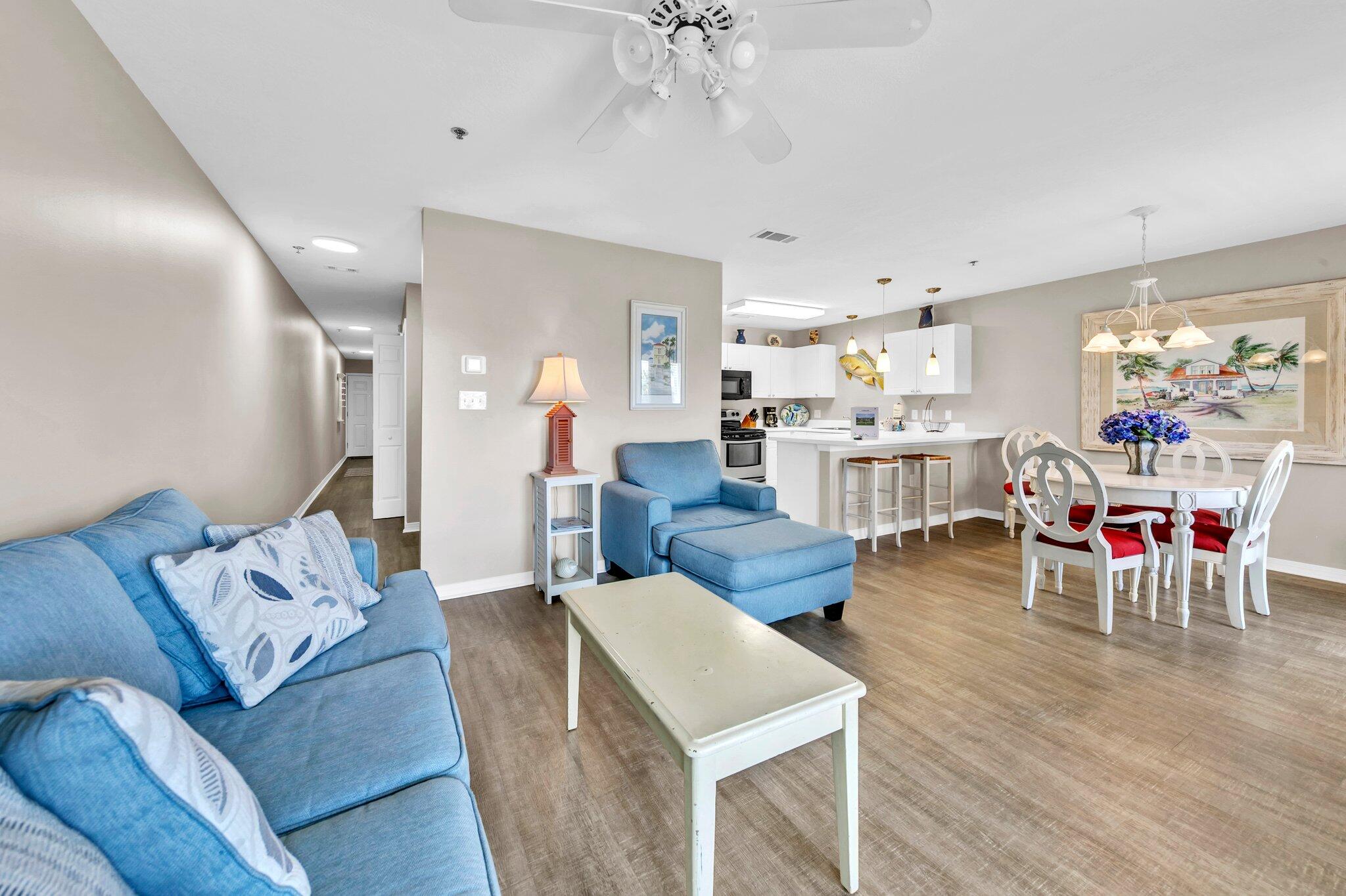 144 Spires Lane, Unit 202 Santa Rosa Beach, FL 32459 - Photo 12 of 31 a living room with furniture and a chandelier