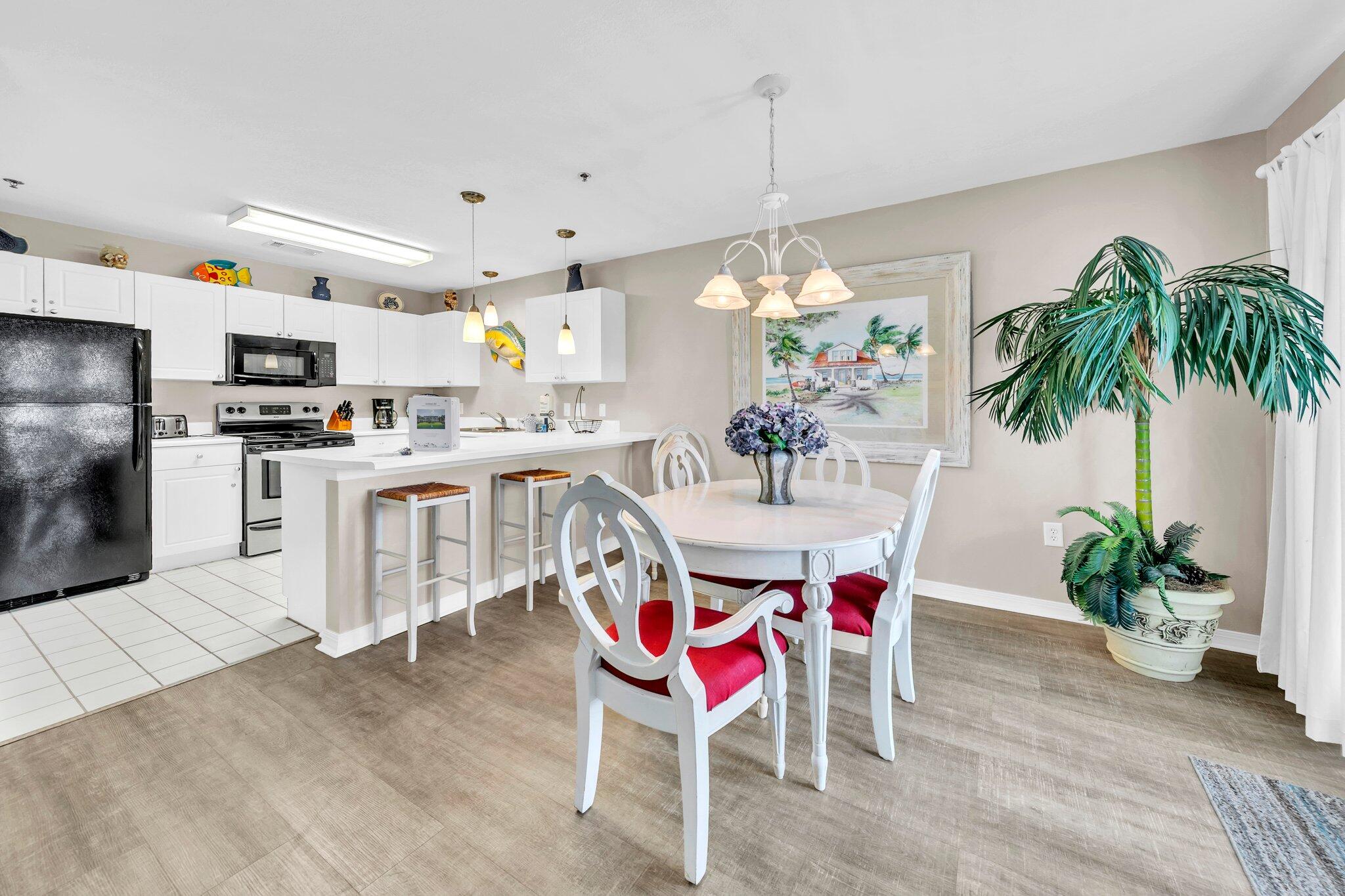 144 Spires Lane, Unit 202 Santa Rosa Beach, FL 32459 - Photo 13 of 31 a dining room with kitchen island a chandelier and living room view
