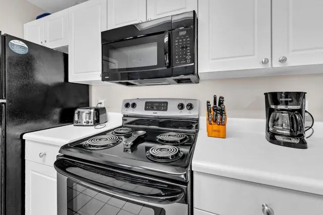 a kitchen with stainless steel appliances granite countertop a stove and a microwave