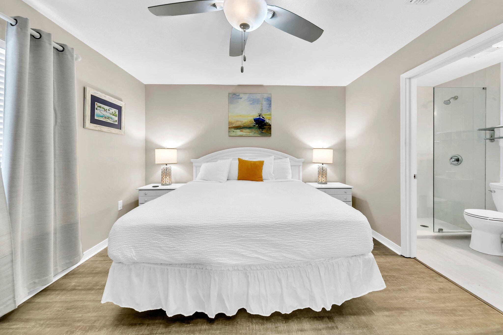 144 Spires Lane, Unit 202 Santa Rosa Beach, FL 32459 - Photo 2 of 31 a bedroom with a bed and a chandelier