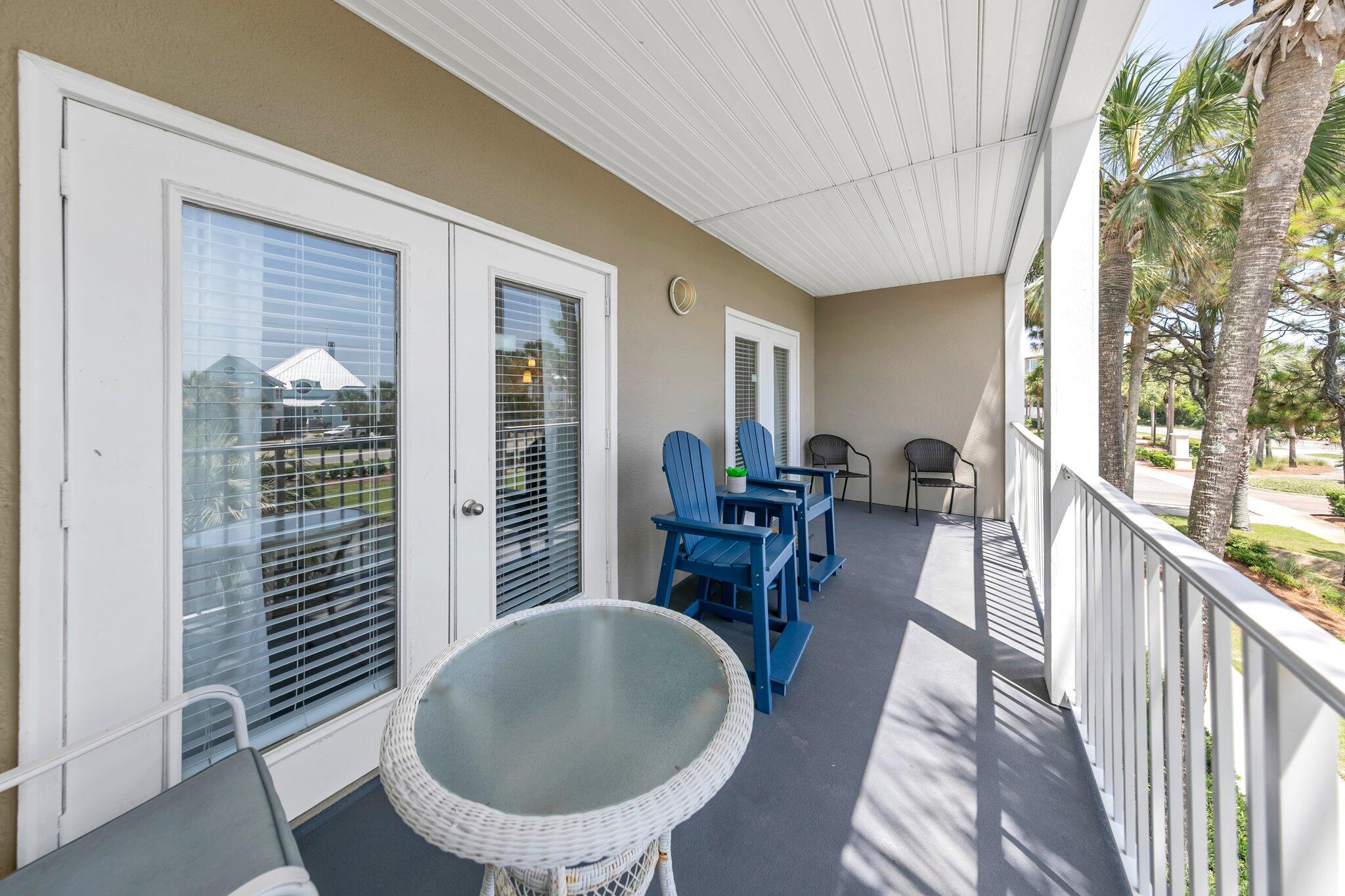 144 Spires Lane, Unit 202 Santa Rosa Beach, FL 32459 - Photo 21 of 31 a dining room with furniture a floor to ceiling window and potted plants