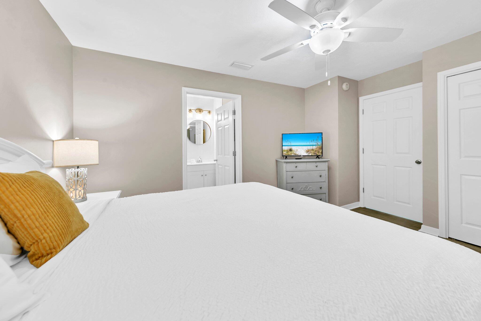 144 Spires Lane, Unit 202 Santa Rosa Beach, FL 32459 - Photo 3 of 31 a bedroom with a bed and a chandelier