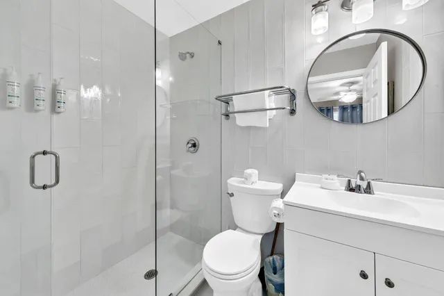 a bathroom with a toilet a sink and mirror
