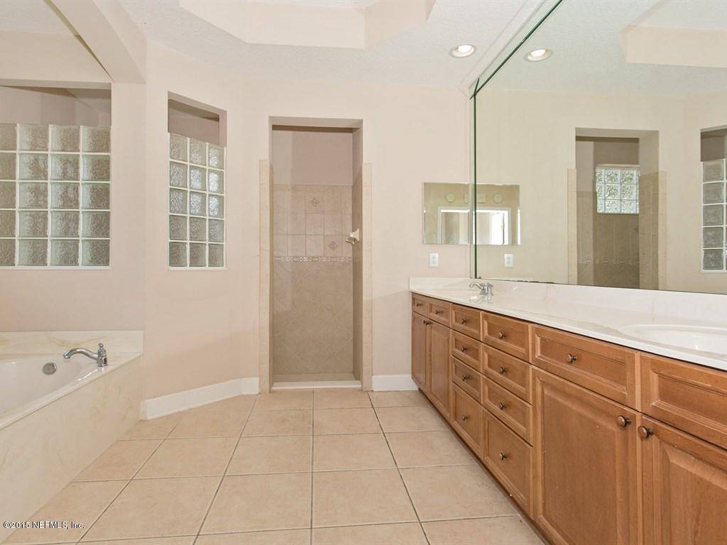 2048 River's Own Road St. Augustine, FL 32092 - Photo 15 of 38 a spacious bathroom with a tub sink and mirror