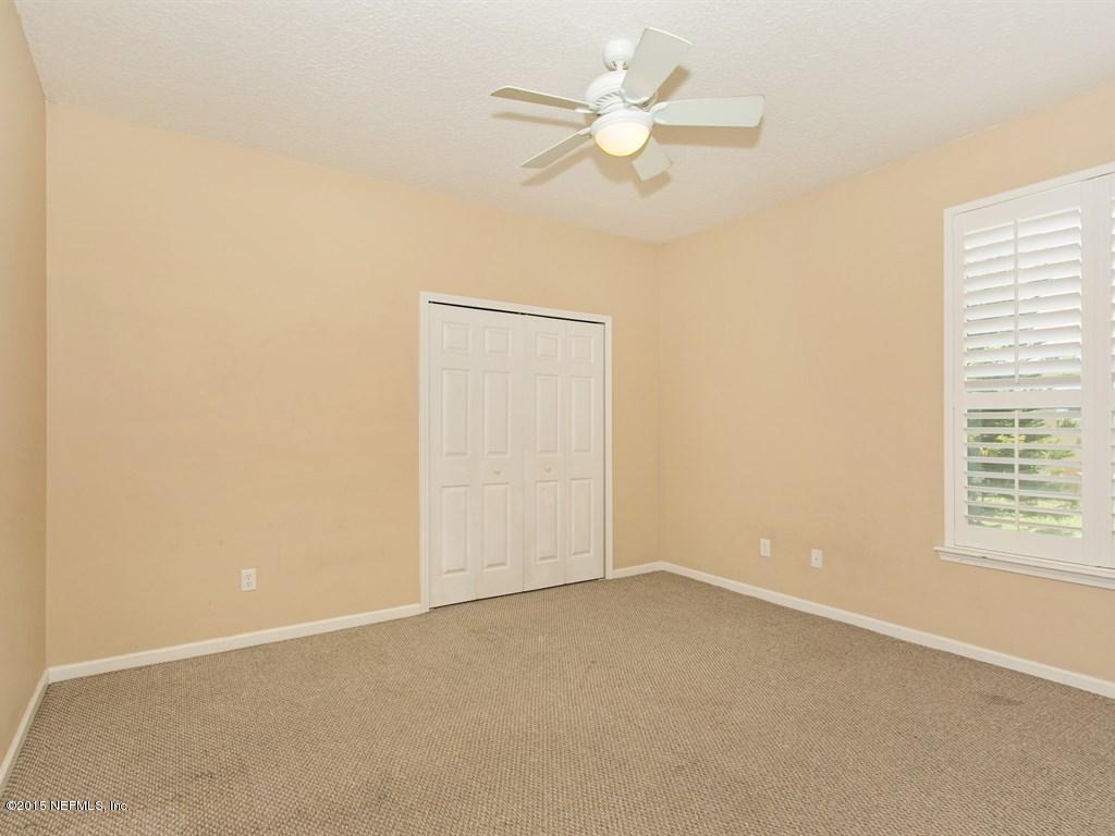 2048 River's Own Road St. Augustine, FL 32092 - Photo 20 of 38 an empty room with a window and a fan