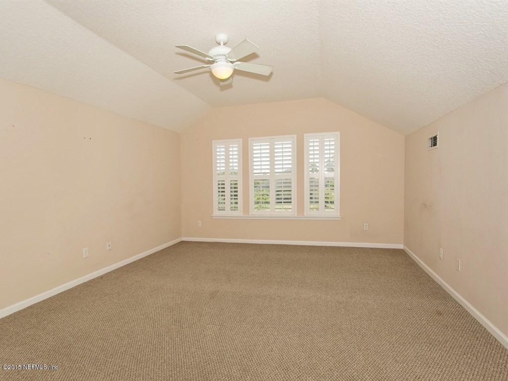 2048 River's Own Road St. Augustine, FL 32092 - Photo 21 of 38 an empty room with windows and fan