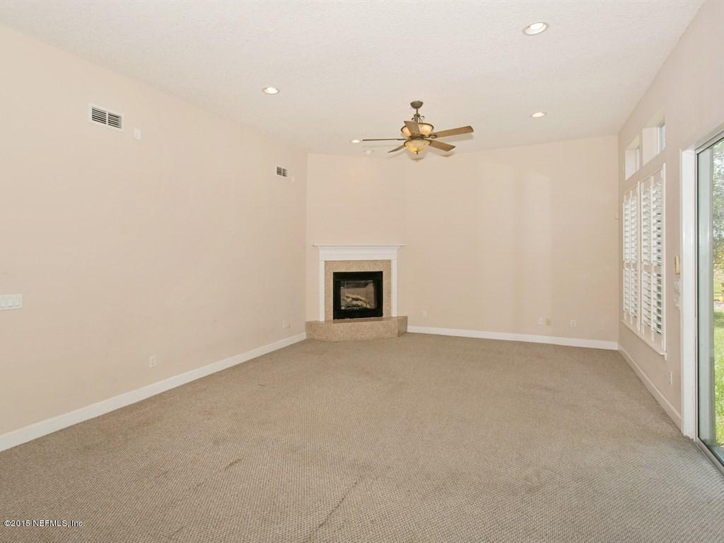 2048 River's Own Road St. Augustine, FL 32092 - Photo 7 of 38 an empty room with a ceiling fan and a window