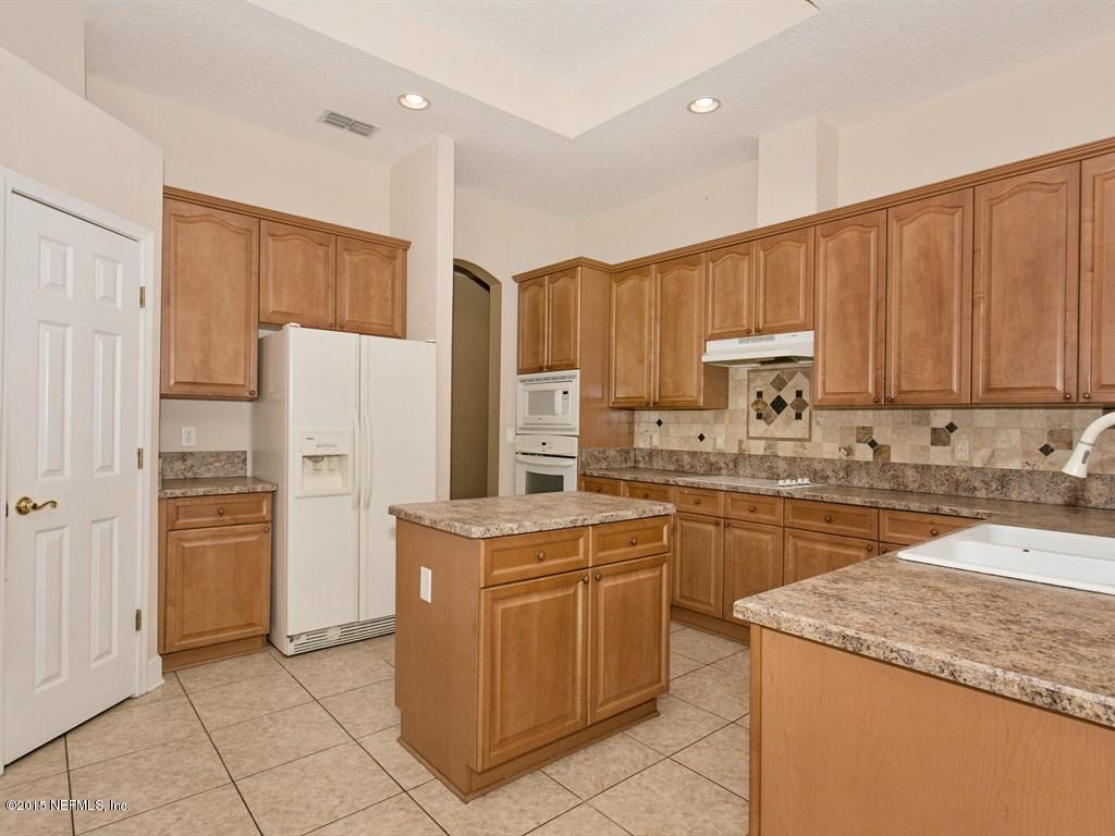 2048 River's Own Road St. Augustine, FL 32092 - Photo 10 of 38 a kitchen with a sink a refrigerator and a microwave