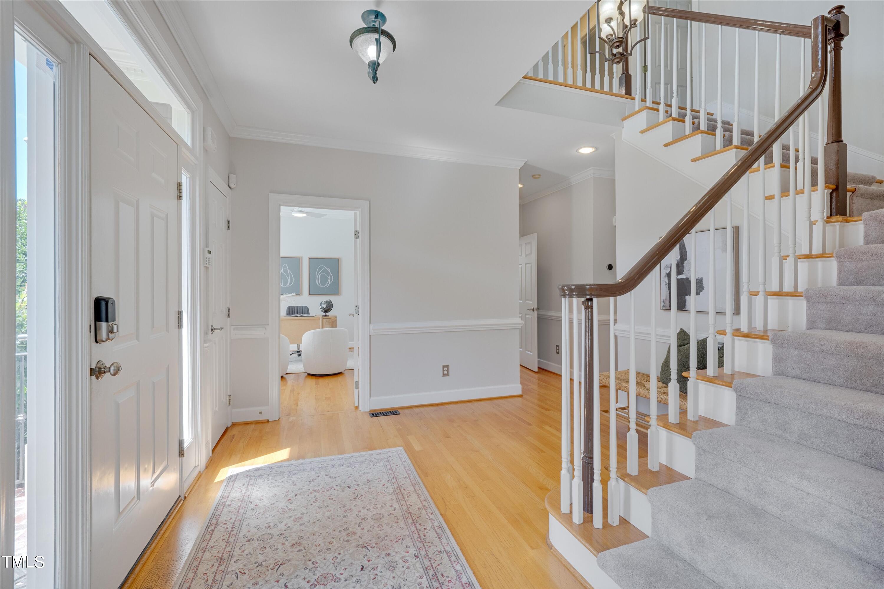 116 Ashworth Drive Durham, NC 27707 - Photo 11 of 60 a view of hallway with wooden floor and staircase