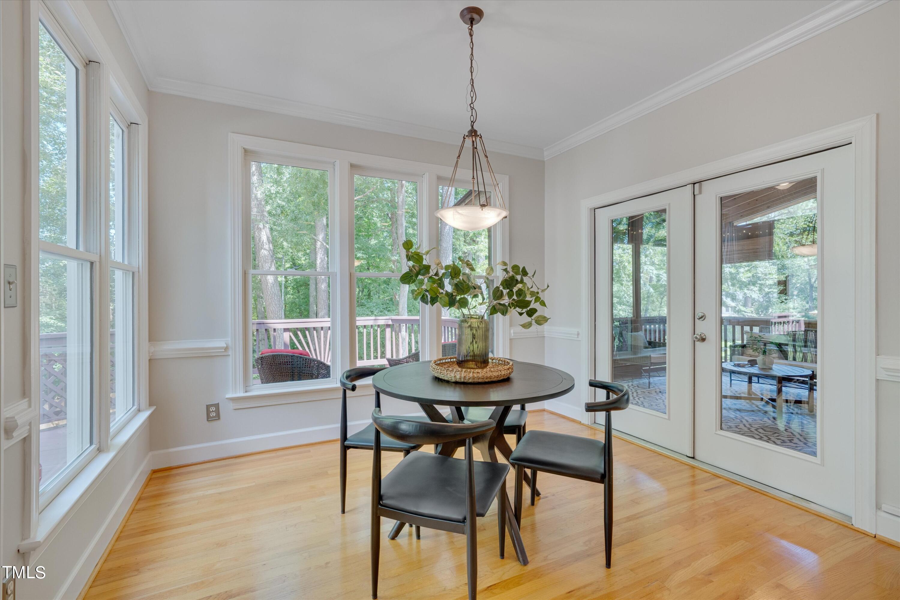 116 Ashworth Drive Durham, NC 27707 - Photo 16 of 60 a dining room with furniture a chandelier and wooden floor