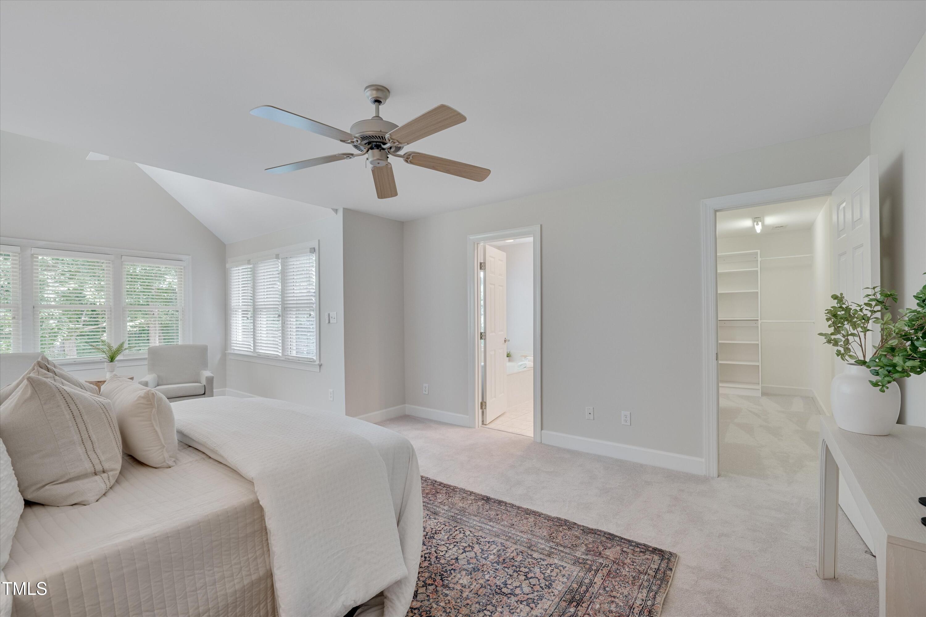 116 Ashworth Drive Durham, NC 27707 - Photo 22 of 60 a spacious bedroom with a bed and a potted plant