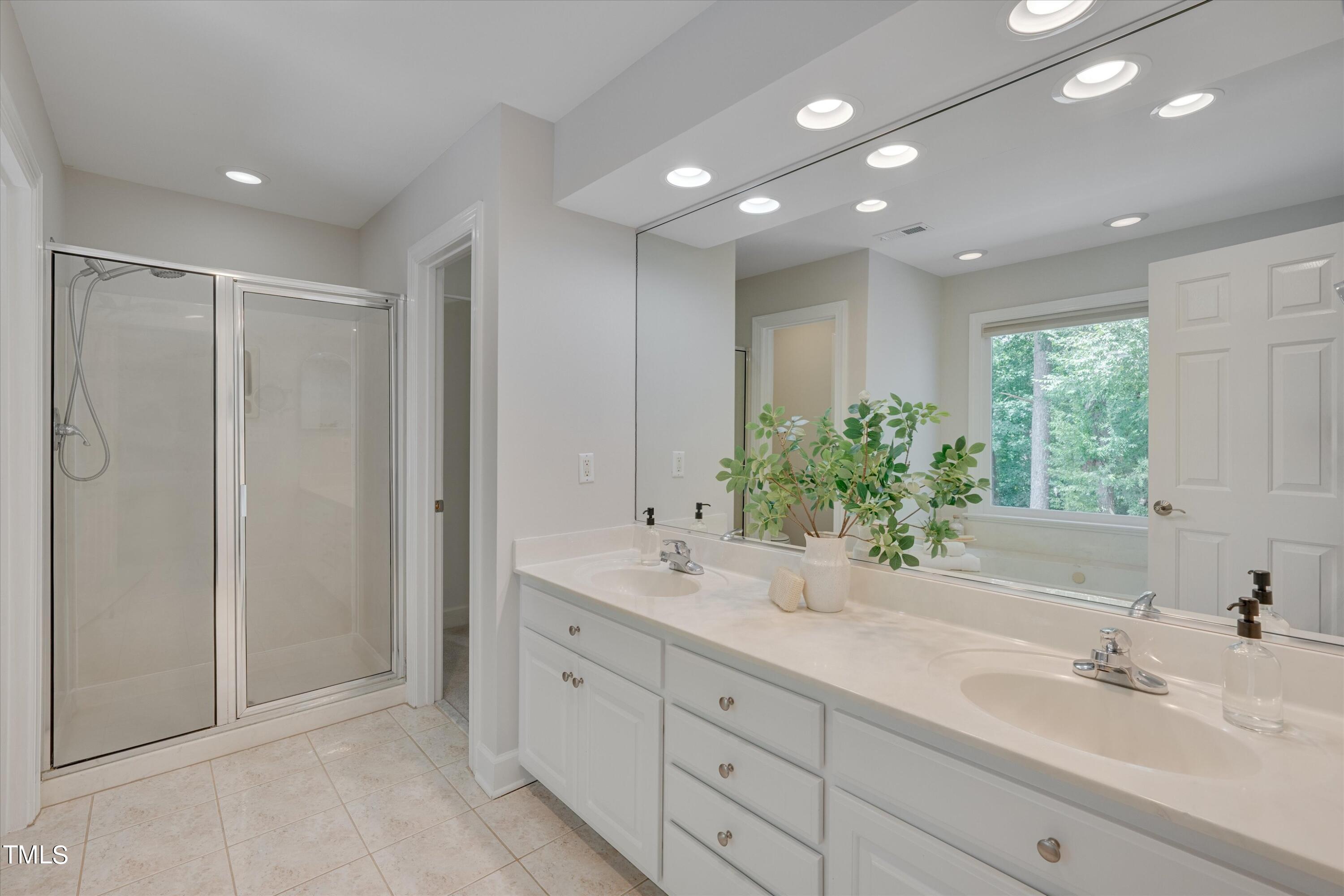 116 Ashworth Drive Durham, NC 27707 - Photo 25 of 60 a bathroom with a double vanity sink and a mirror