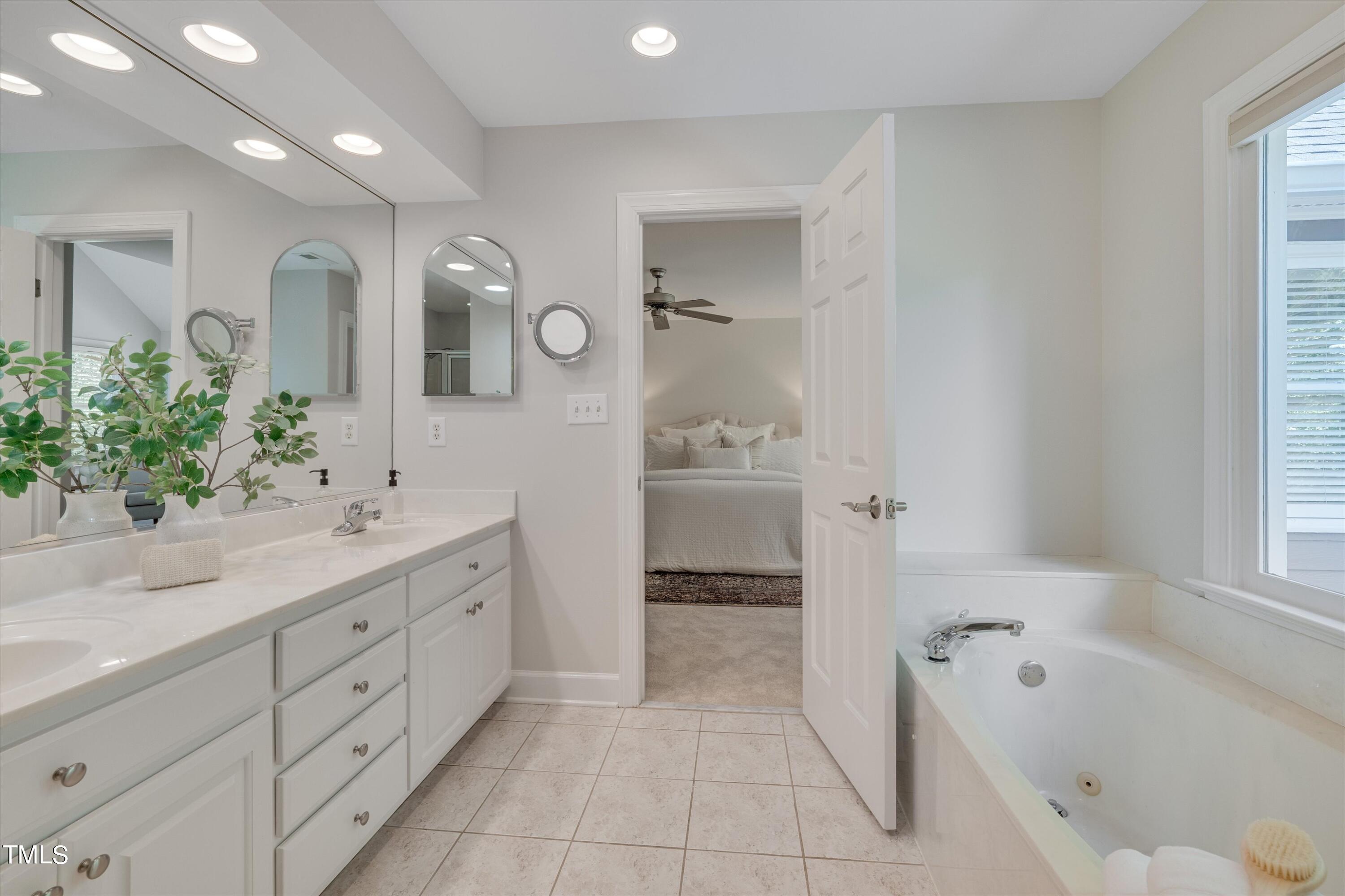 116 Ashworth Drive Durham, NC 27707 - Photo 26 of 60 a spacious bathroom with a tub sink and mirror