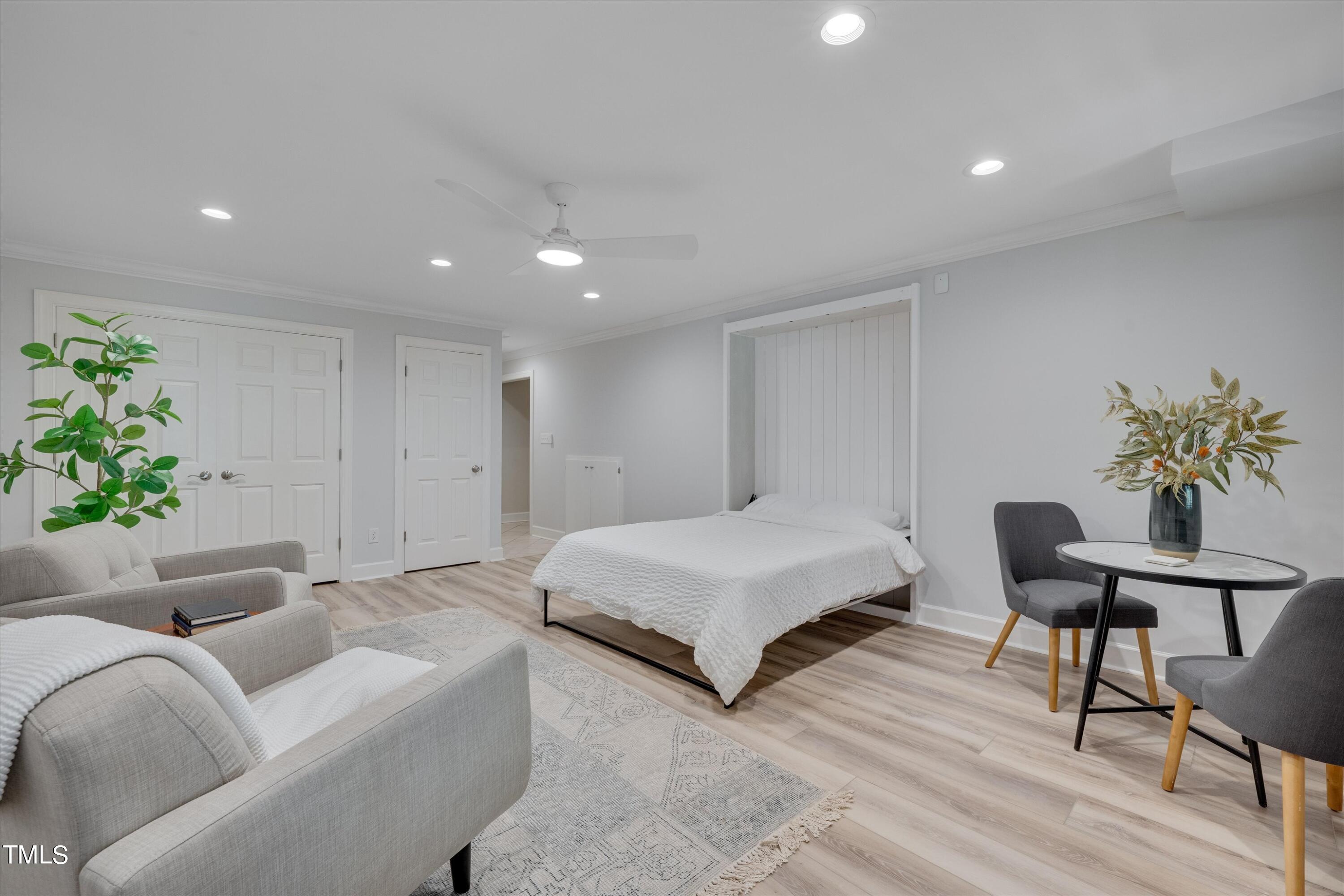 116 Ashworth Drive Durham, NC 27707 - Photo 6 of 60 a spacious bedroom with a bed and a chair