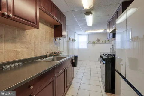 a kitchen with a sink and refrigerator