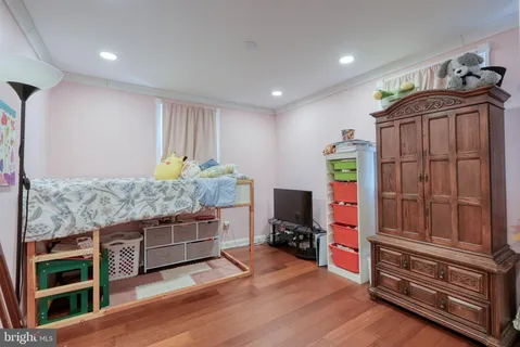 a living room with furniture flat screen tv and a wooden floor