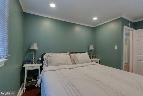 a bedroom with a bed and a night stand
