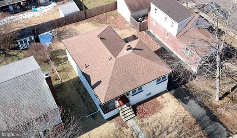 an aerial view of a house with a yard and furniture
