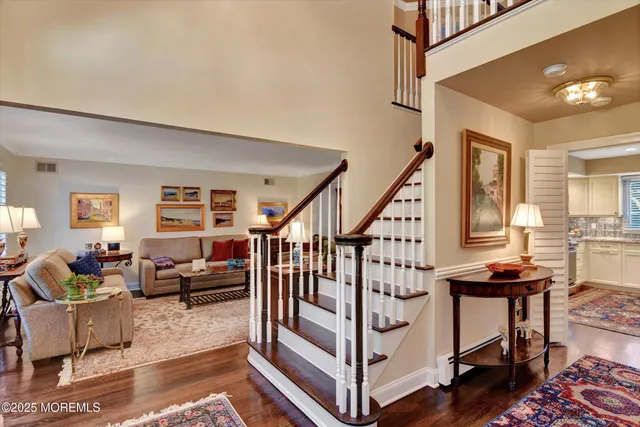 a view of entryway livingroom and hall with wooden floor