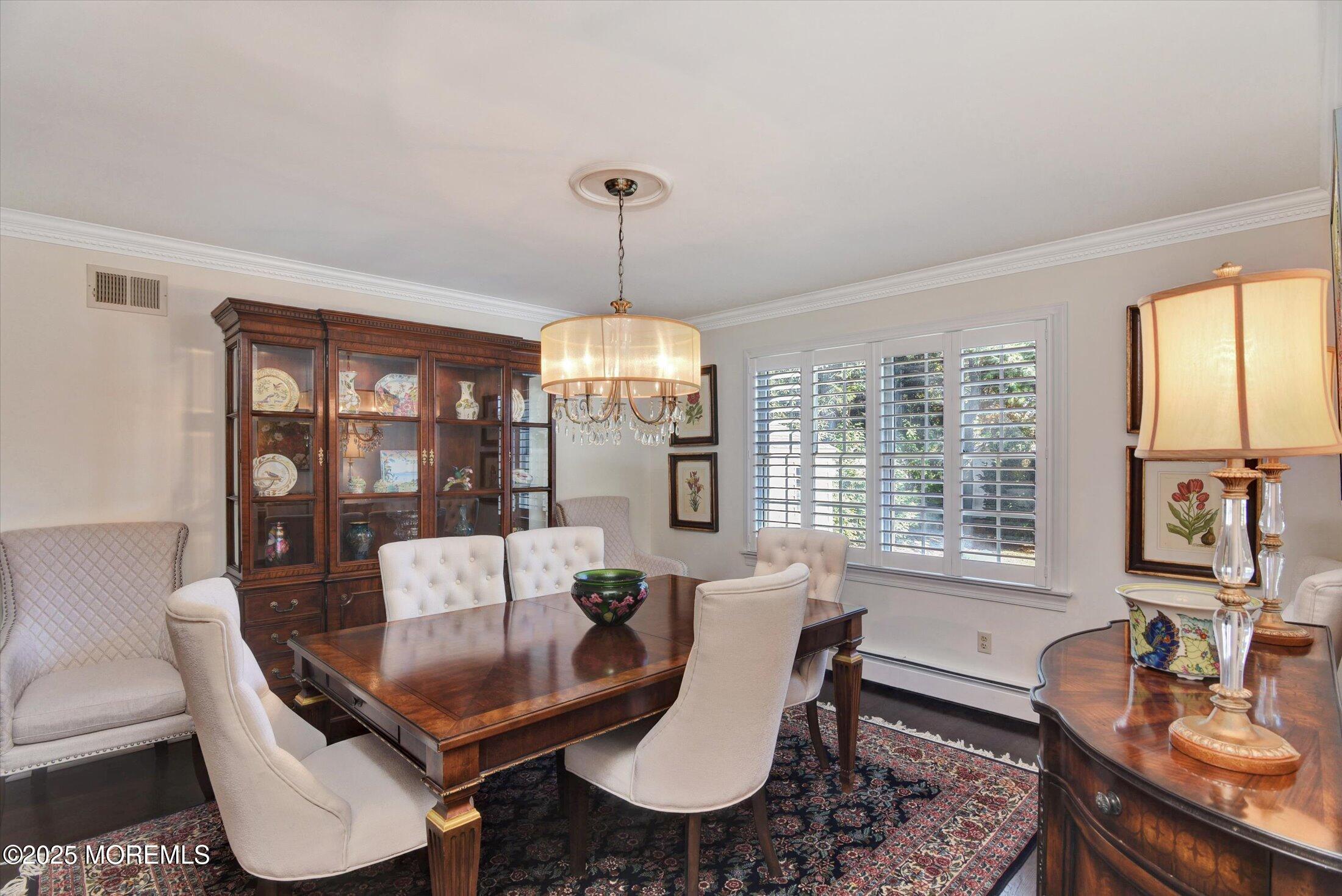 14 Lebanon Drive Brielle, NJ 08730 - Photo 11 of 42 a dining room with furniture a chandelier and wooden floor