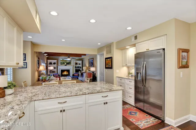 a kitchen with stainless steel appliances granite countertop a refrigerator and a sink