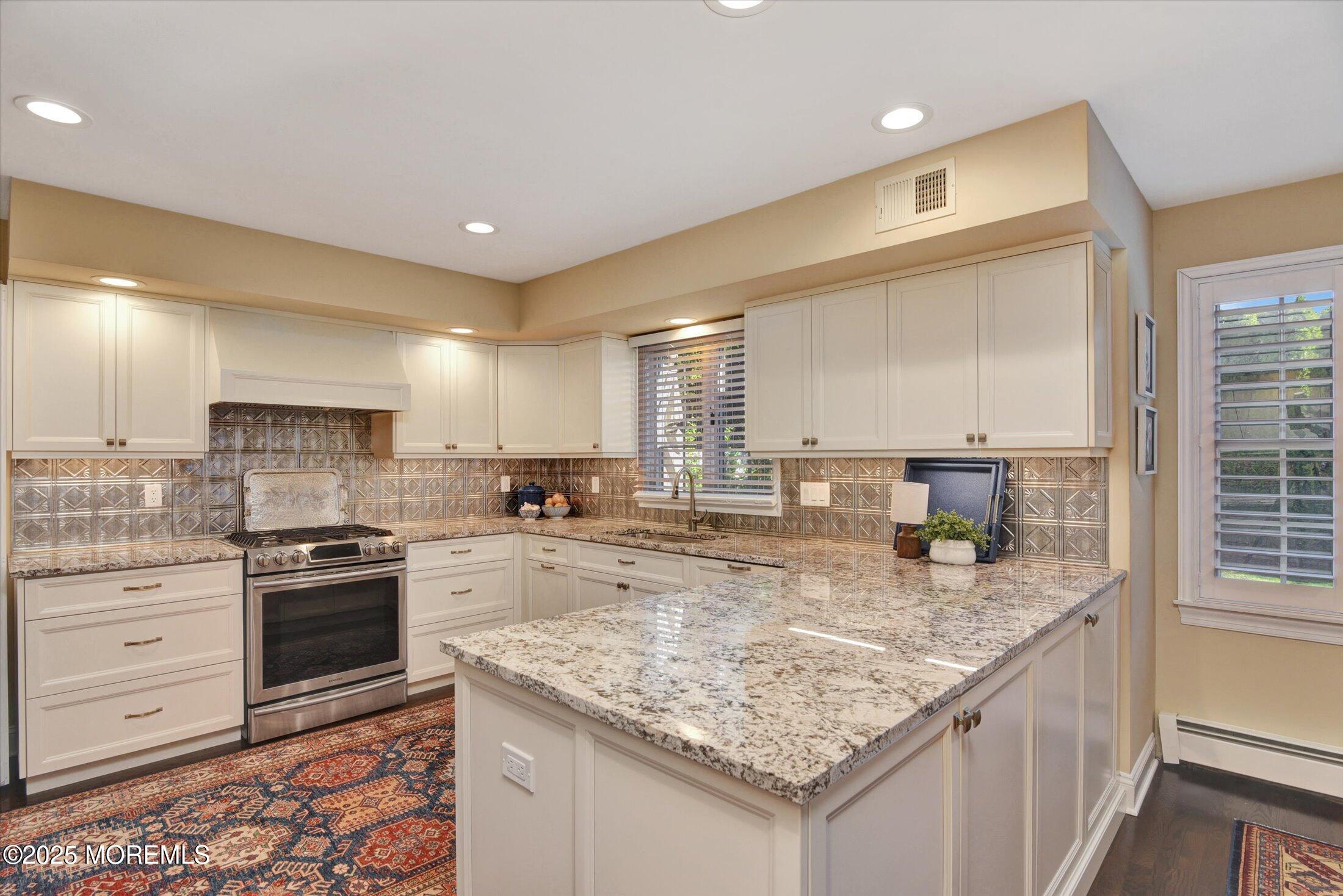 14 Lebanon Drive Brielle, NJ 08730 - Photo 16 of 42 a kitchen with stainless steel appliances granite countertop a sink stove and cabinets