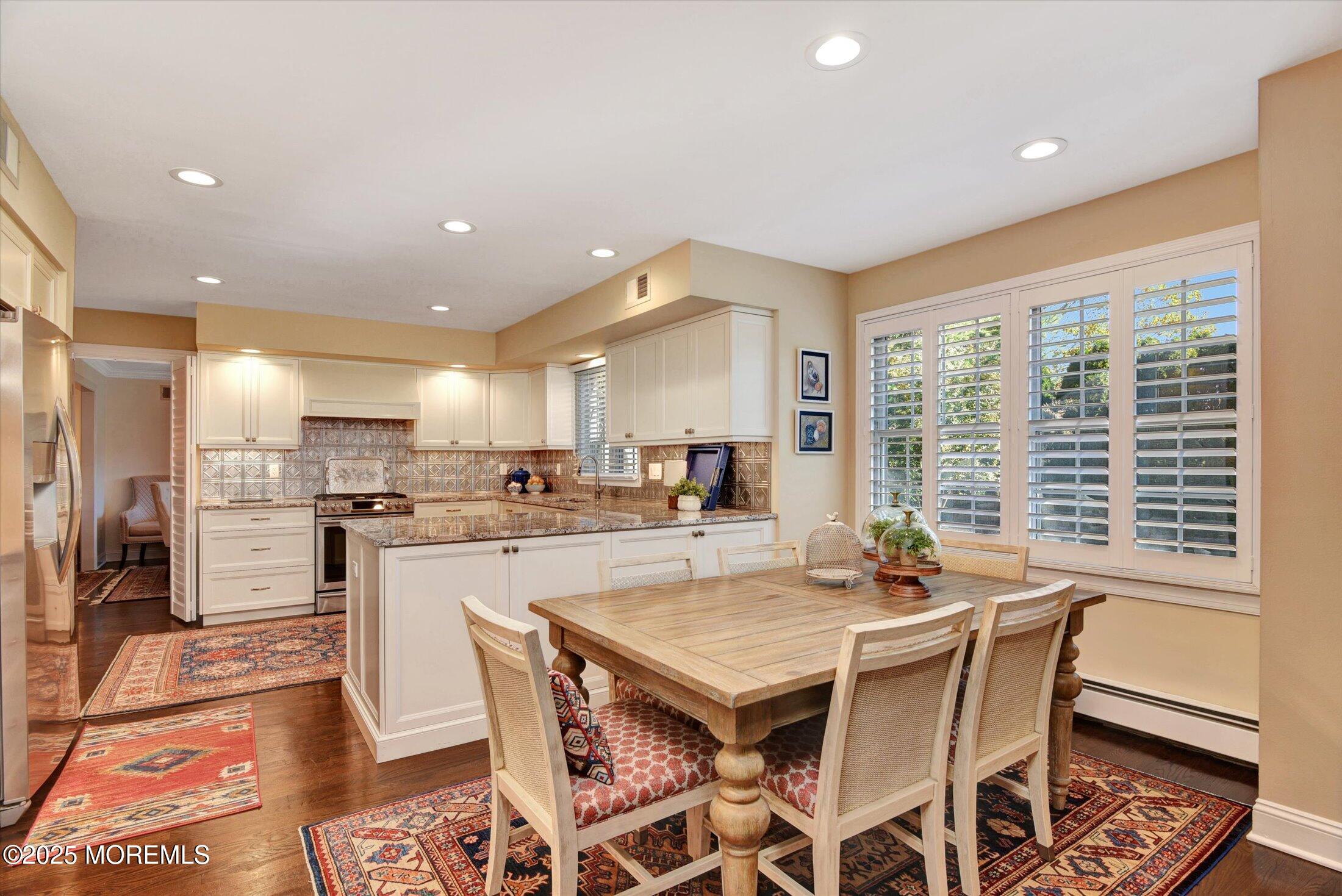 14 Lebanon Drive Brielle, NJ 08730 - Photo 18 of 42 a dining room with stainless steel appliances kitchen island granite countertop a dining table and chairs