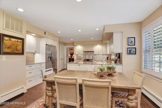 a kitchen with stainless steel appliances kitchen island granite countertop a sink and cabinets
