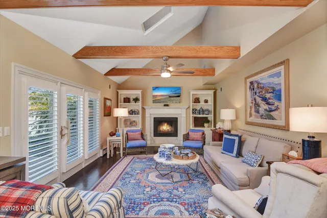 a living room with furniture a fireplace and a large window