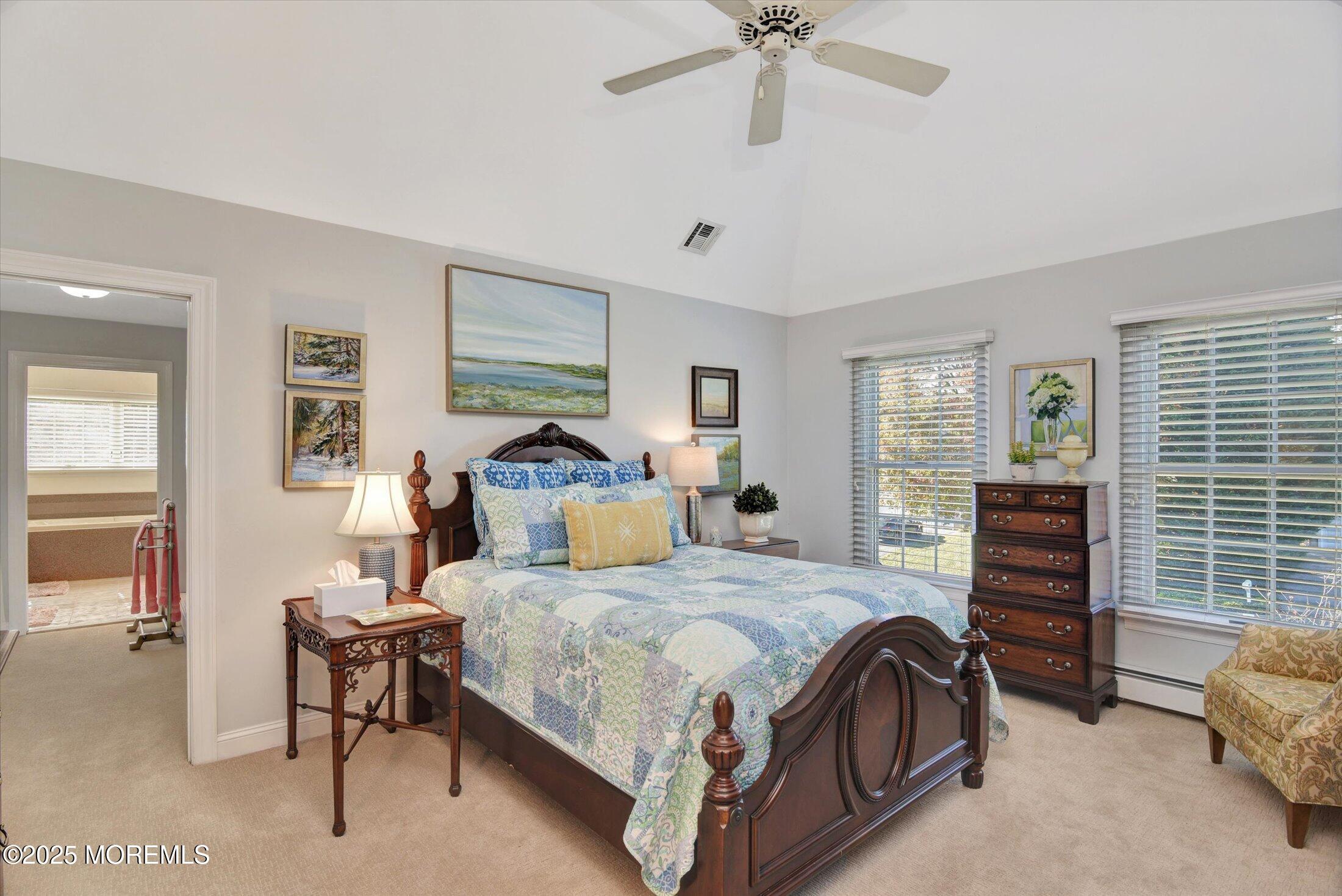 14 Lebanon Drive Brielle, NJ 08730 - Photo 24 of 42 a bedroom with a bed and a chandelier