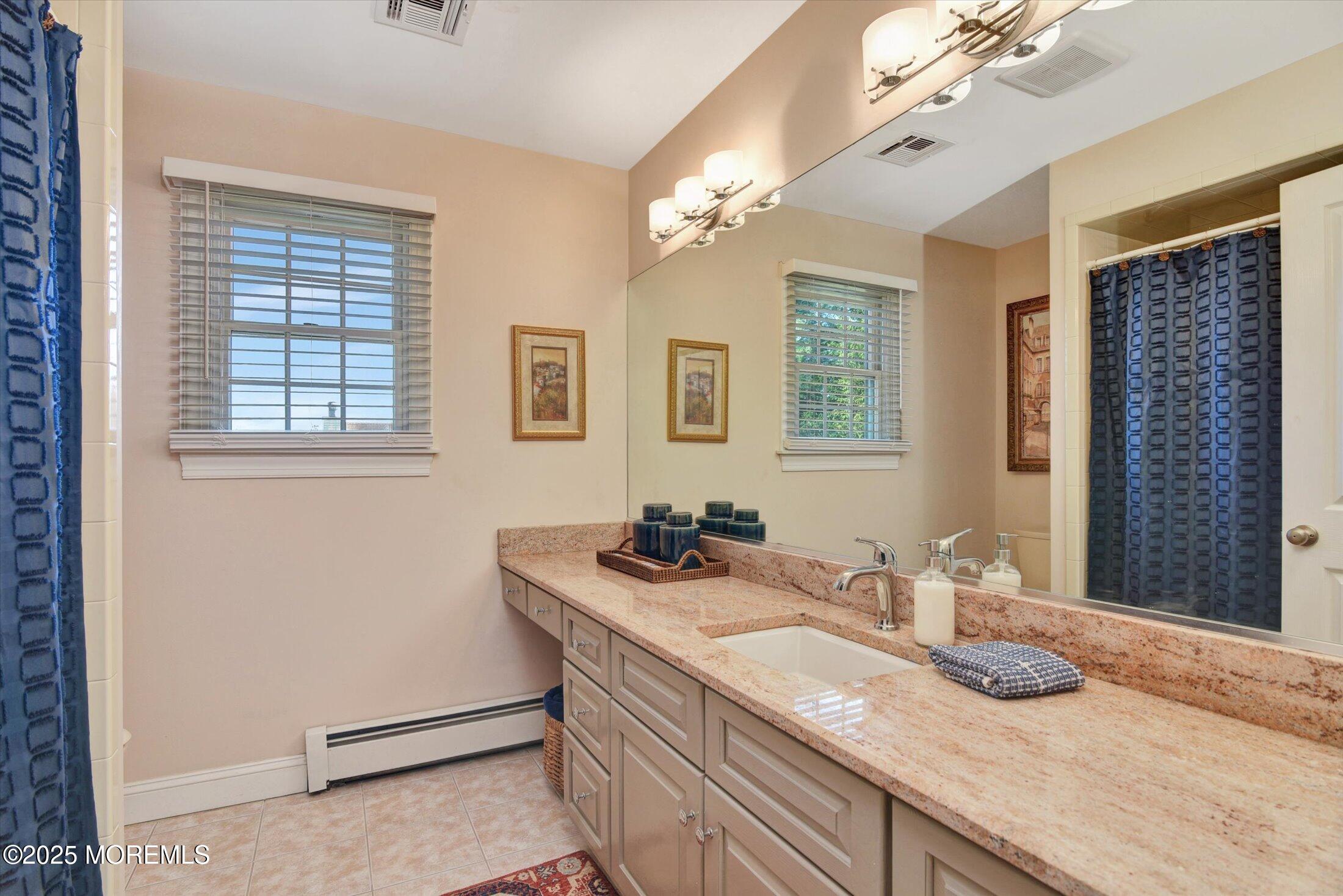 14 Lebanon Drive Brielle, NJ 08730 - Photo 30 of 42 a bathroom with a granite countertop sink a large mirror and a shower