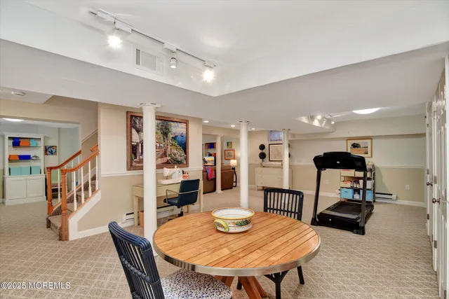 a living room with furniture and a dining table