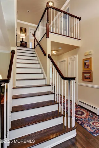 a view of entryway with wooden floor and stairs